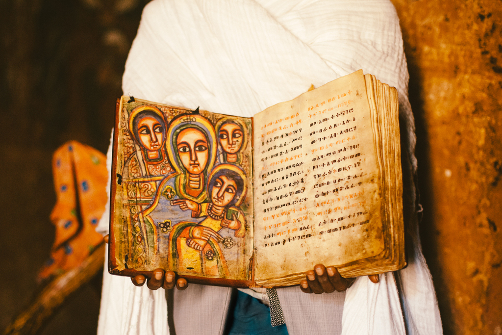 A preist showing a few hundred-year-old bible in the rock-hewn churches in Tigray in Ethiopia